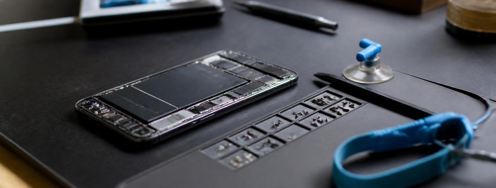 Technician replacing a smartphone screen with precision tools at the Tech Repairs Dundee bench